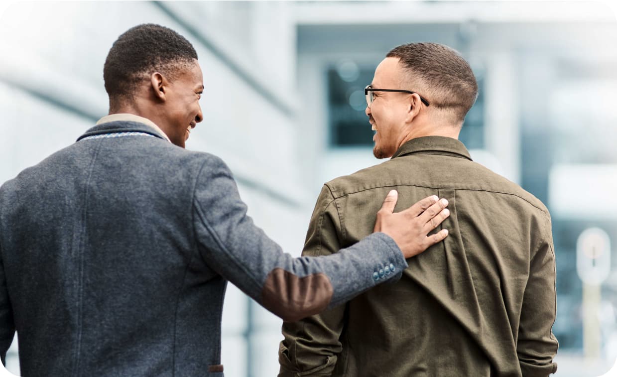 Supportive coworker and colleague feeling happy about job opportunity or promotion while walking in city during lunch break.