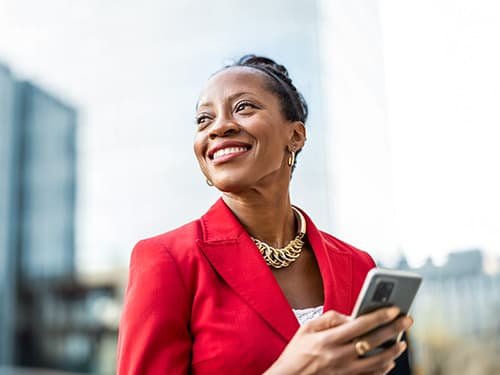 Portrait of smiling mature businesswoman using mobile phone in urban setting. Portrait of smiling mature businesswoman using mobile phone in urban setting.